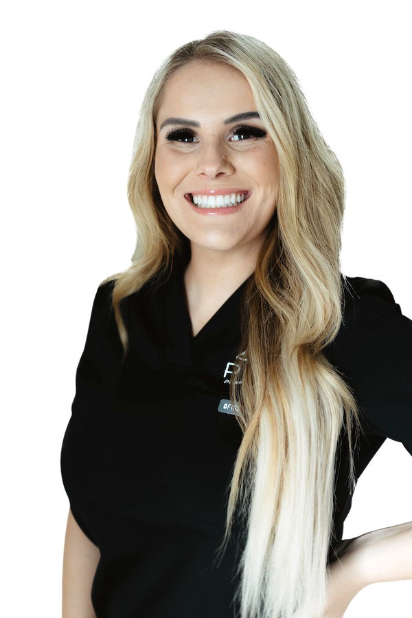A woman with long blonde hair wearing a black top smiles at the camera against a plain white background.
